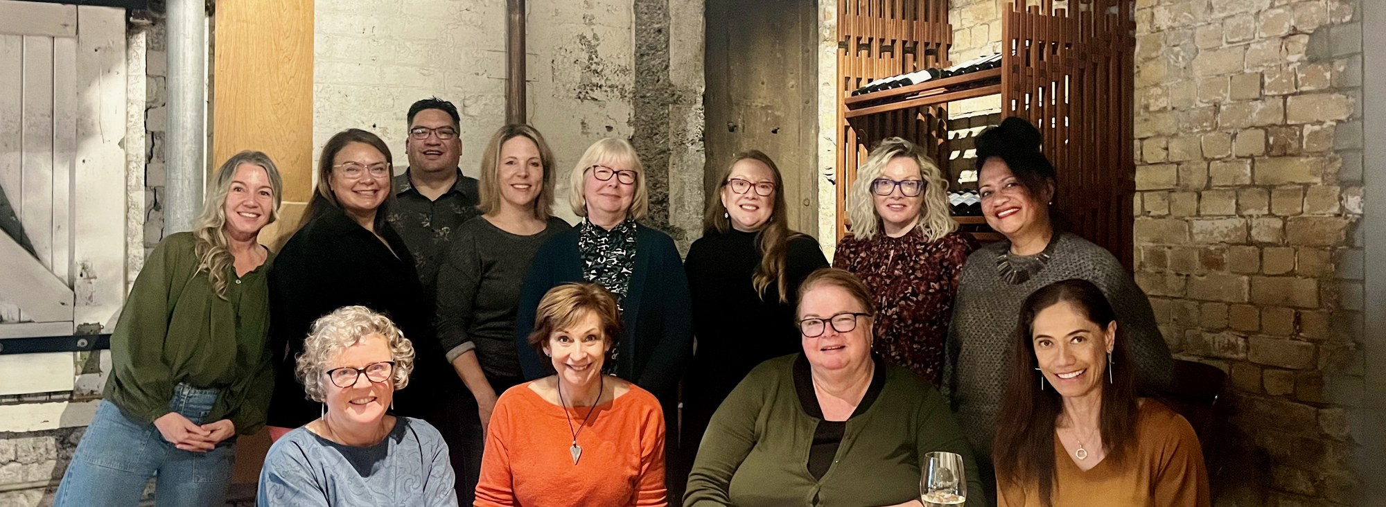 The Harris Shea team and wider bench of associates, gathered around a long table